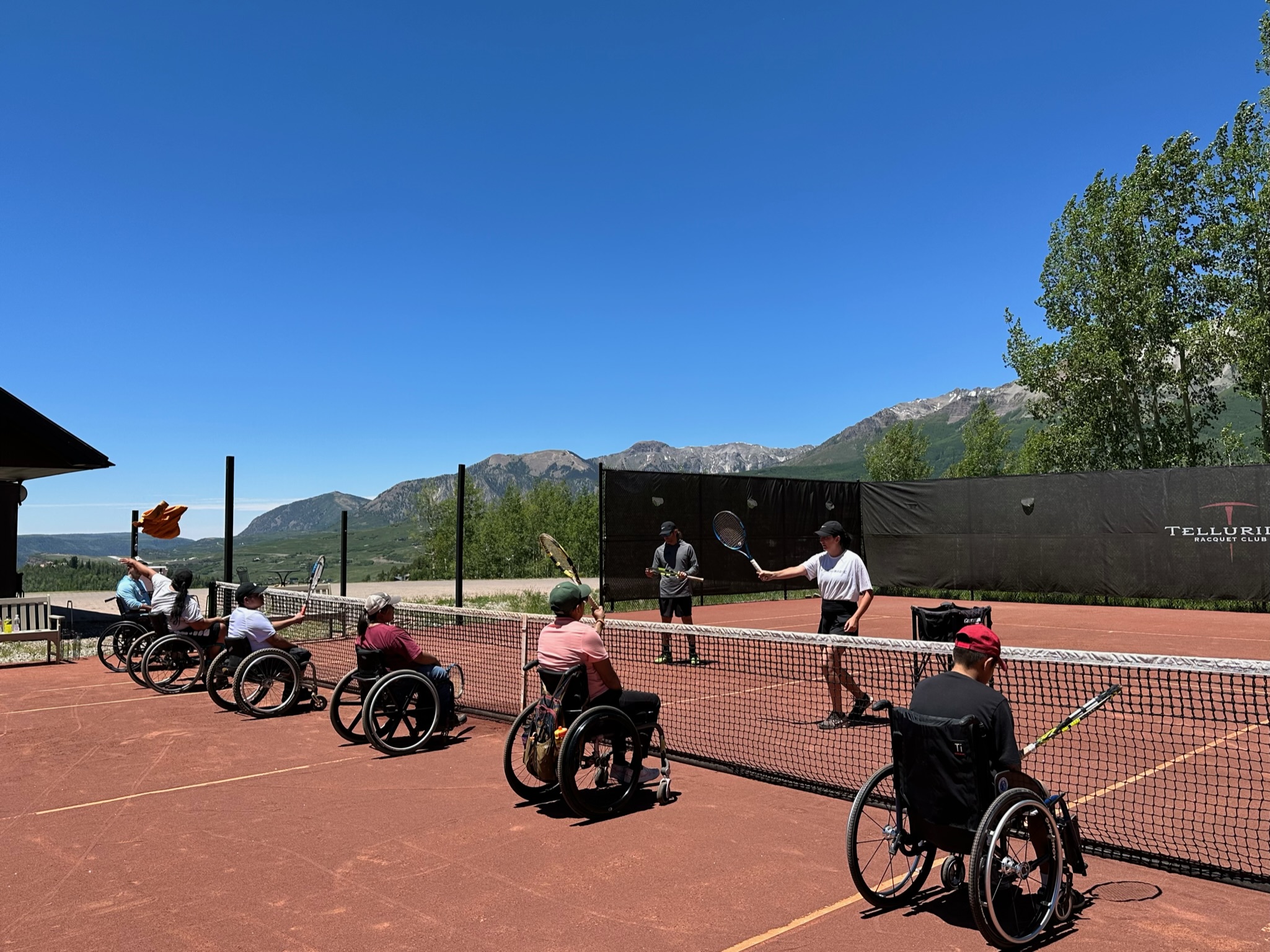 People playing tennis in wheelchairs